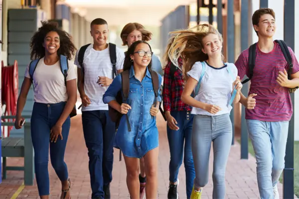 a group of smiling students transitioning from middle to high school