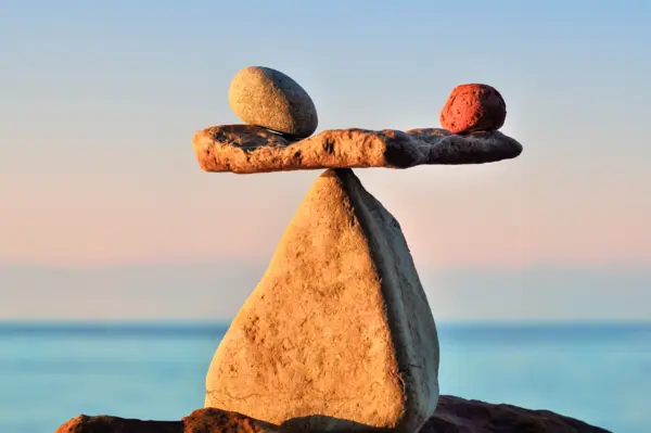 A balancing scale made of rocks that has found equilibrium, embodying the importance of wellness for educators