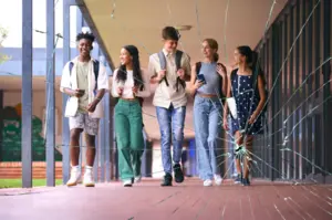 Students walking down a hallway with a cracked glass effect in the foreground